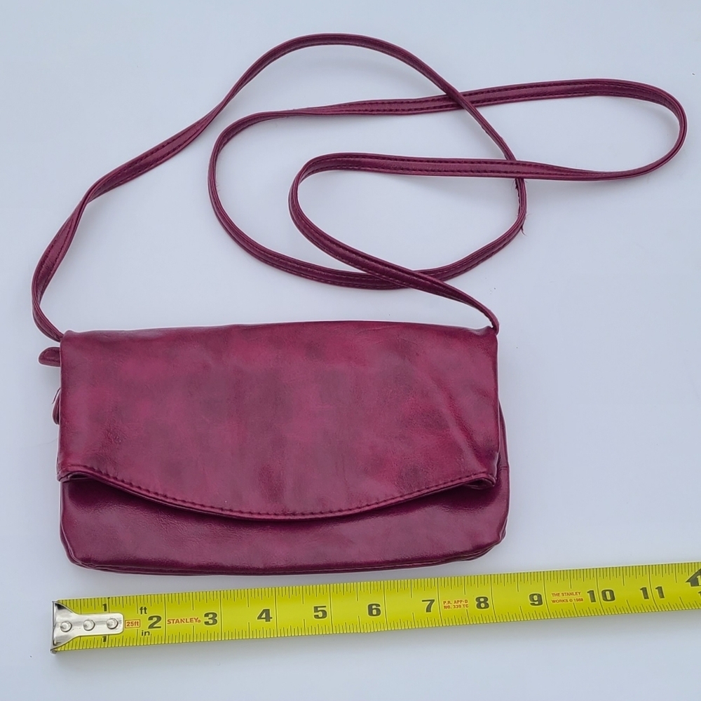 Dark pink purse crossbody folds into small wallet size purse with zippers